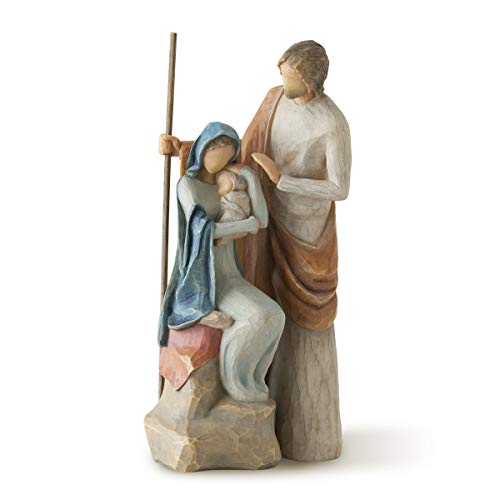 A hand-painted nativity figure set depicting the Holy Family, with Joseph, Mary, and baby Jesus on a stone base.