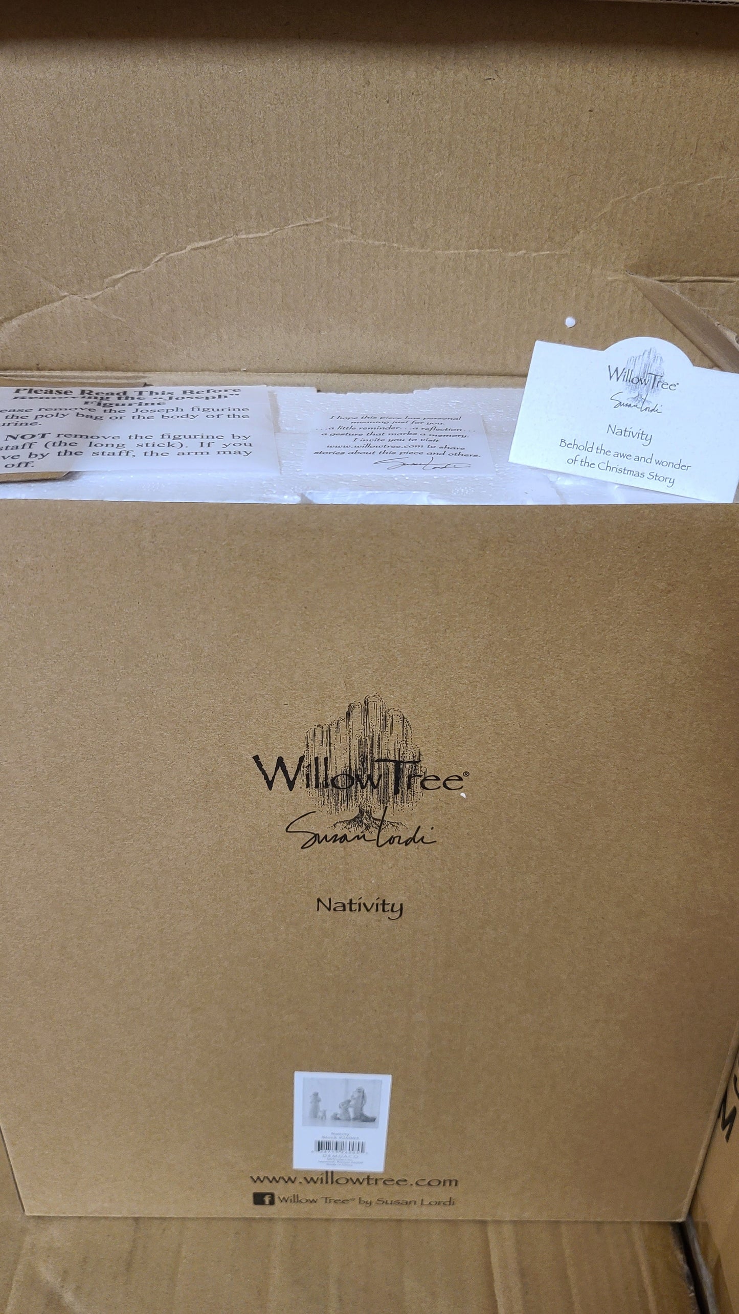 A set of hand-painted resin nativity figures, including figures of Joseph, Mary, a shepherd, a donkey, and two sheep, placed on a marble surface.