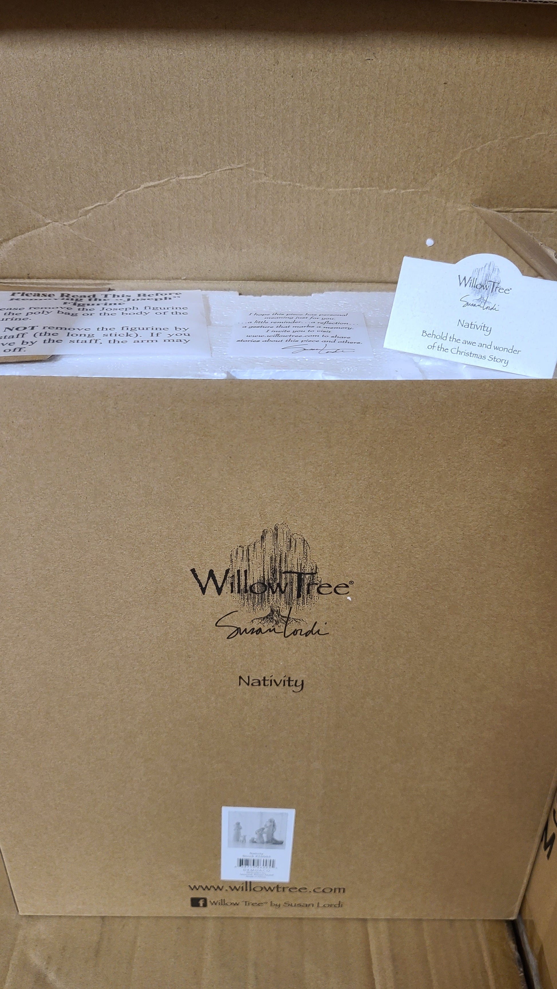 A set of hand-painted resin nativity figures, including figures of Joseph, Mary, a shepherd, a donkey, and two sheep, placed on a marble surface.