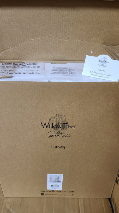 A set of hand-painted resin nativity figures, including figures of Joseph, Mary, a shepherd, a donkey, and two sheep, placed on a marble surface.